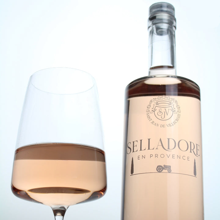 Bottle and glass of Selladore En Provence rosé wine on a white background