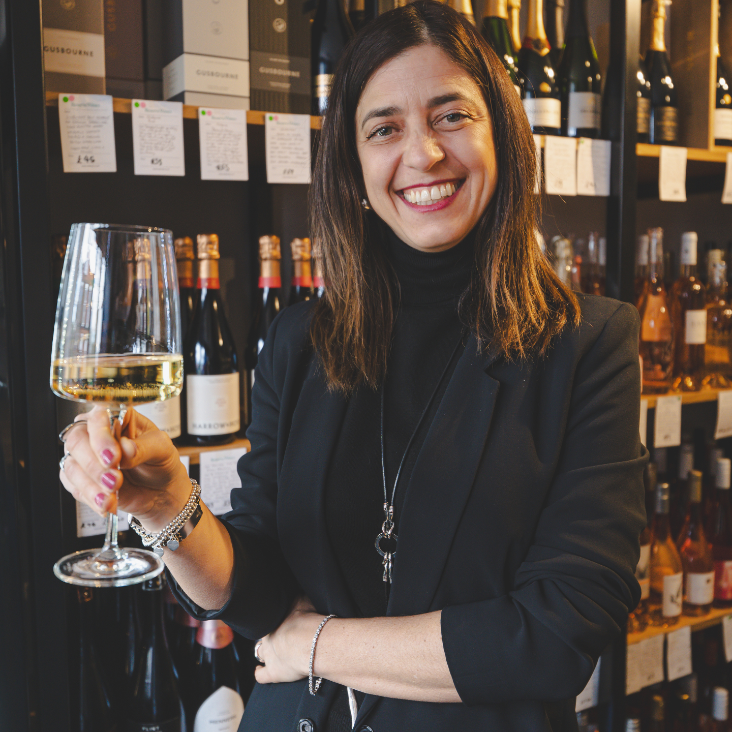 Style Expert Maria Vittoria smiling warmly while holding a glass of white wine