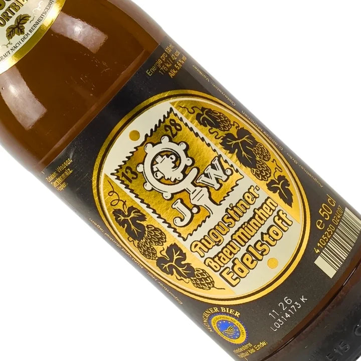 Bottle label with gold and black design featuring text and symbols on a white background