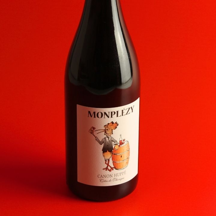 Domaine Monplezy, Canon Huppe Rouge 2025 bottle on a red background