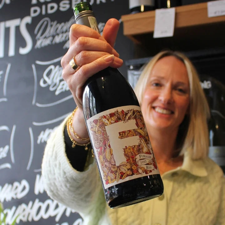 Kate Goodman holding a bottle of Forage Red in the West Didsbury Reserve Wines shop