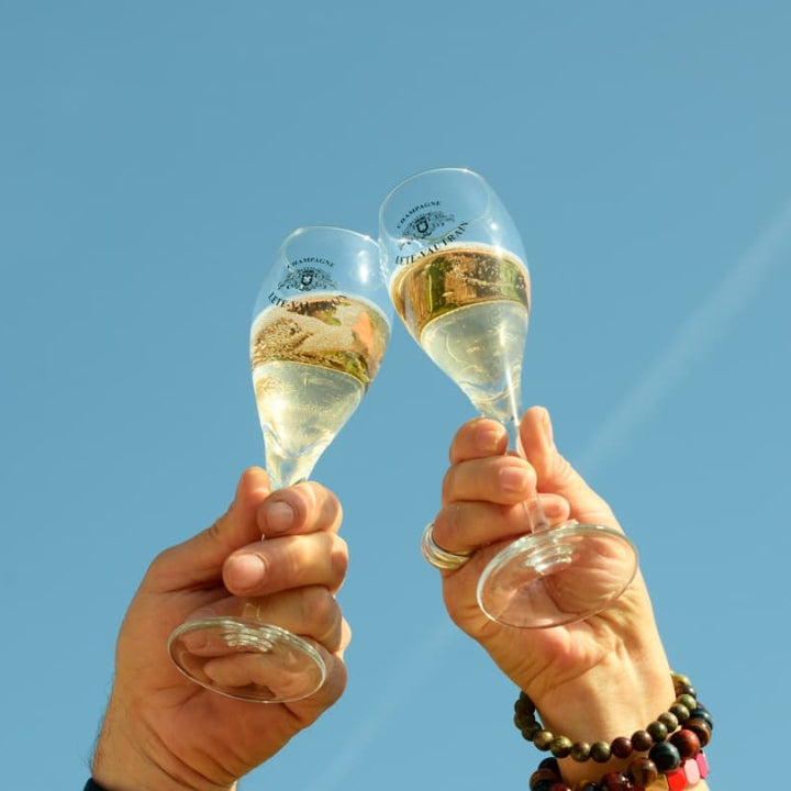 Champagne Glasses up to a blue sky