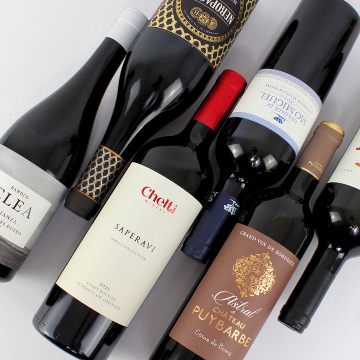 Collection of wine bottles with various labels on a white background