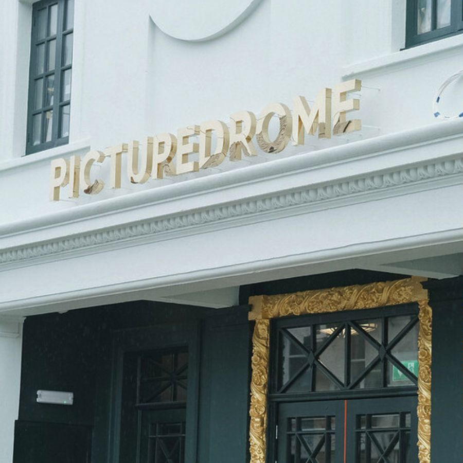 Left: 'PICTUREDROME' sign on a building, Right: People at a bar with drinks and decor.