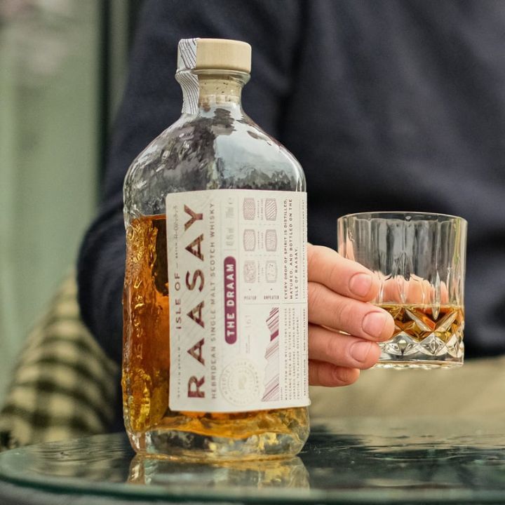 Raasay The Draam Single malt Whisky and glass in hand