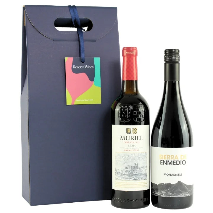Two wine bottles with labels in front of a gift box labeled 'Reserve Wines'.