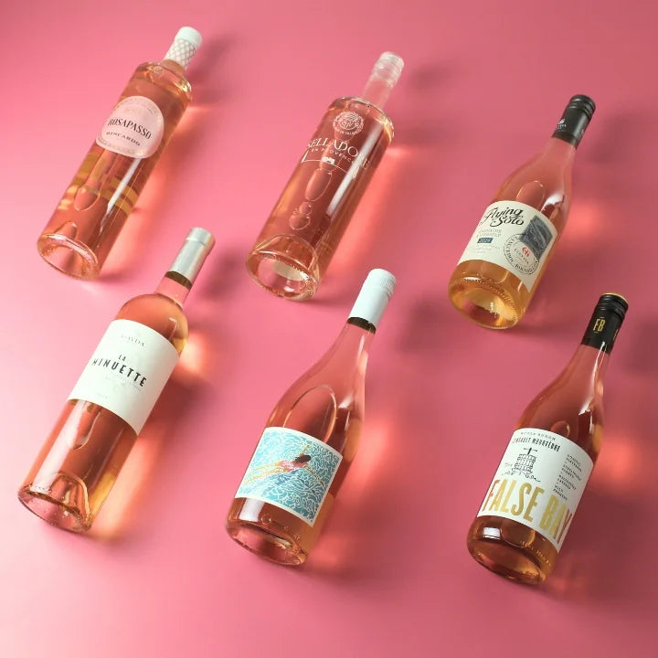 six rose bottles on a pick background