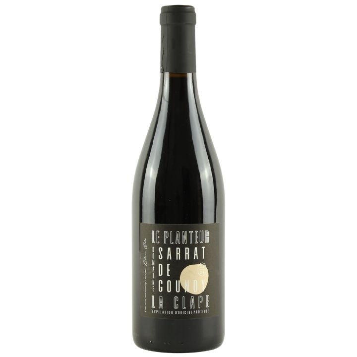 A bottle of Le Planteur Sarrat de Goundy La Clape red wine, featuring a dark glass bottle with a black capsule and a dark gray label with gold and white text.