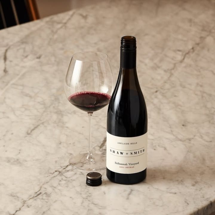 a bottle of Shaw + Smith &#39;Balhannah Vineyard Adelaide Hills Shiraz 2021 sits on top of a marble table