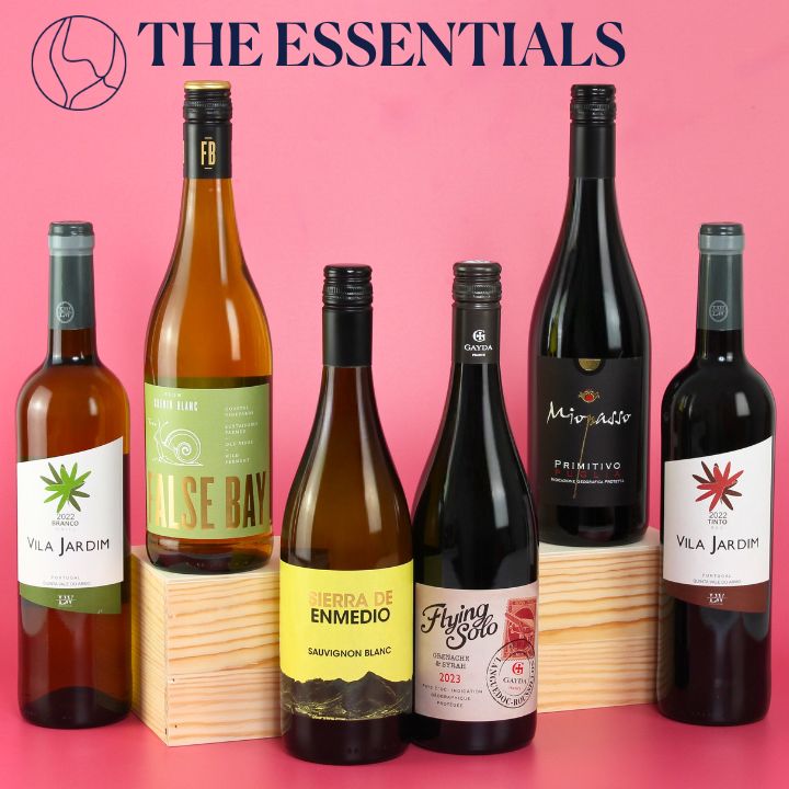 Collection of wine bottles with visible labels on a pink background, featuring 'The Essentials' branding.
