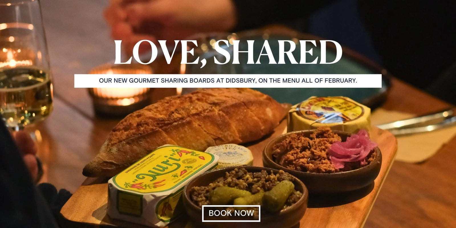 Gourmet sharing board with bread and spreads on a wooden board, with text overlay about a new menu offer.