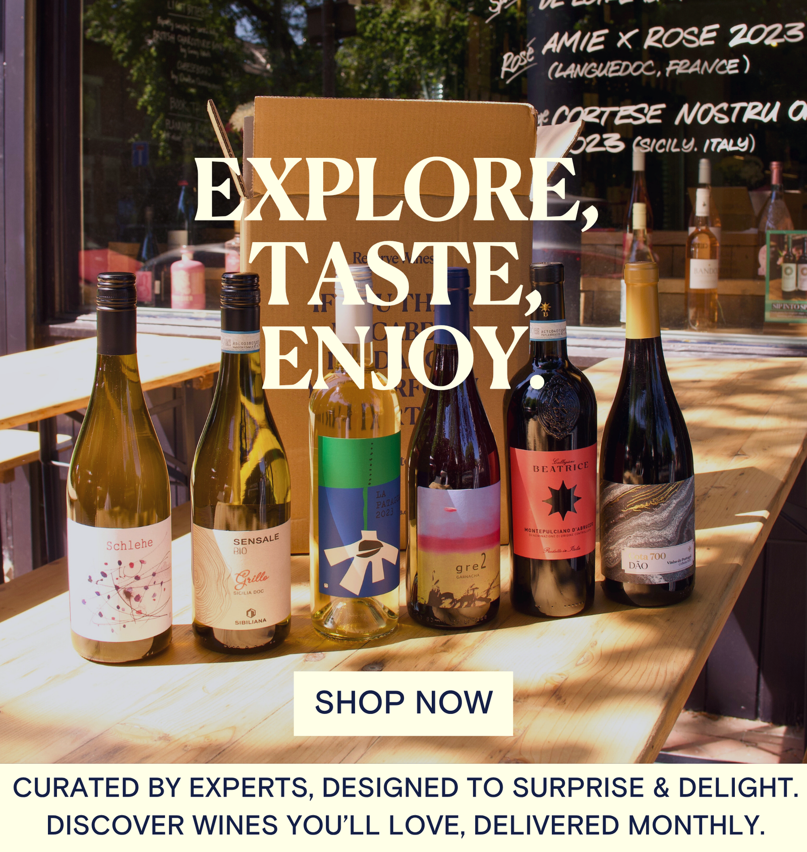 Wine bottles on a table with 'Explore, Taste, Enjoy' text and a call to action to shop now  - Reserve Wines